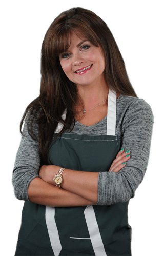 Victoria Arpels, founder of Next Step Beauty, smiling in a black apron